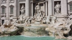 The blinding sunlight reflecting off the pearly white marbel of the Trevi Fountain. 